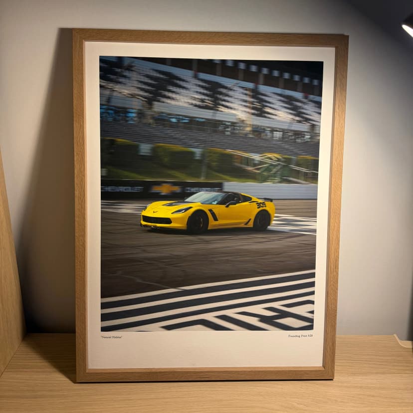 Framed custom poster on a clean concrete wall
